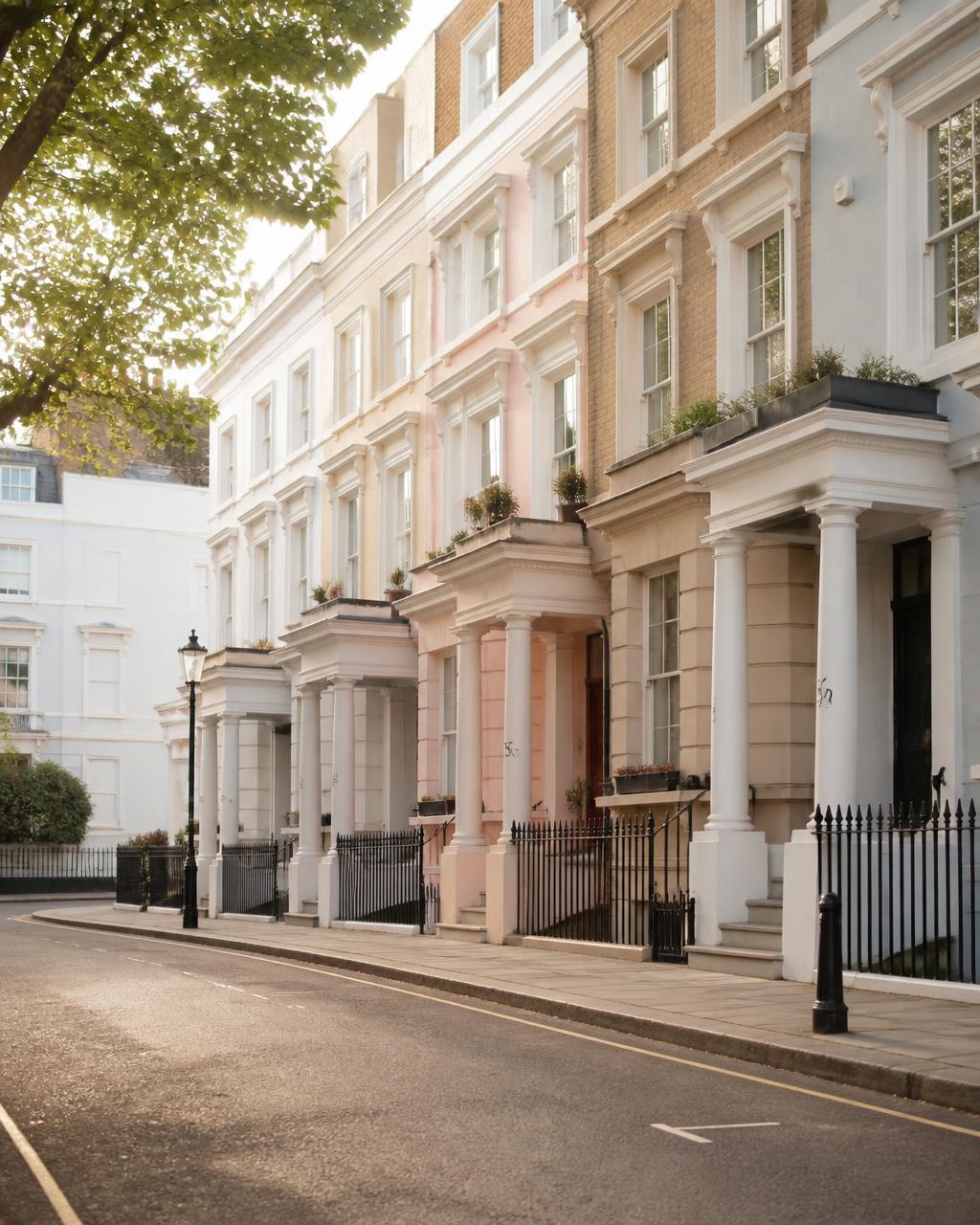Pastel stucco terraced houses on a quiet Notting Hill street